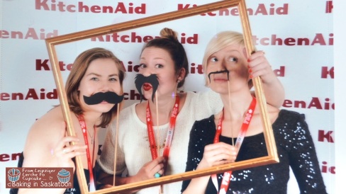 Andrea MacLeod, Kelly Brison and Kris are being silly in the KitchenAid photo booth.